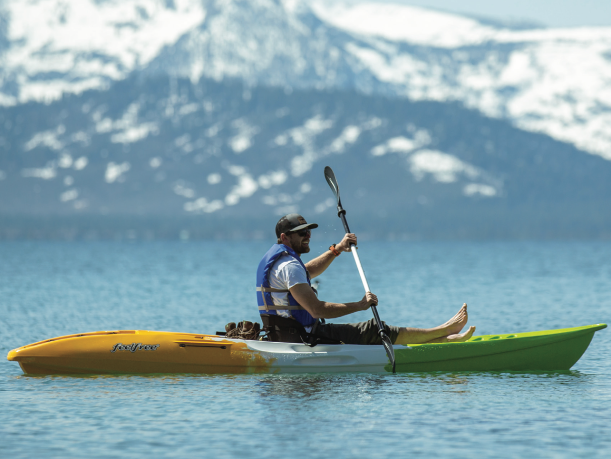 a man riding on the back of a boat in a body of water